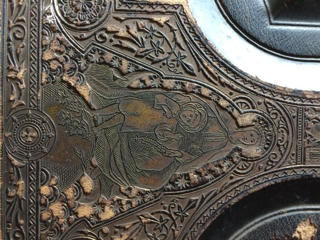 Some of the detail on the cover, which features impressed Roman Catholic symbols.