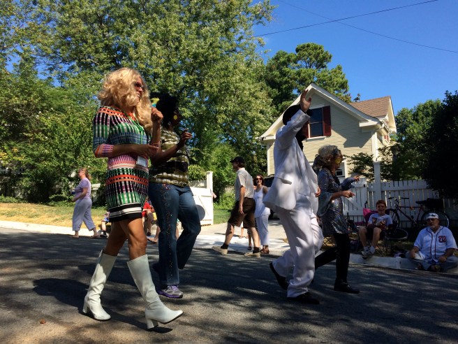 A bunch of crazy youthful hippies, with Elvis, of course. What's a parade without Elvis?