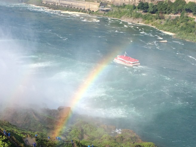 The American-side tourist boat, the Maid of the Mist, is blue. The Canadian-side tourist boat, the Hornblower, is red. 