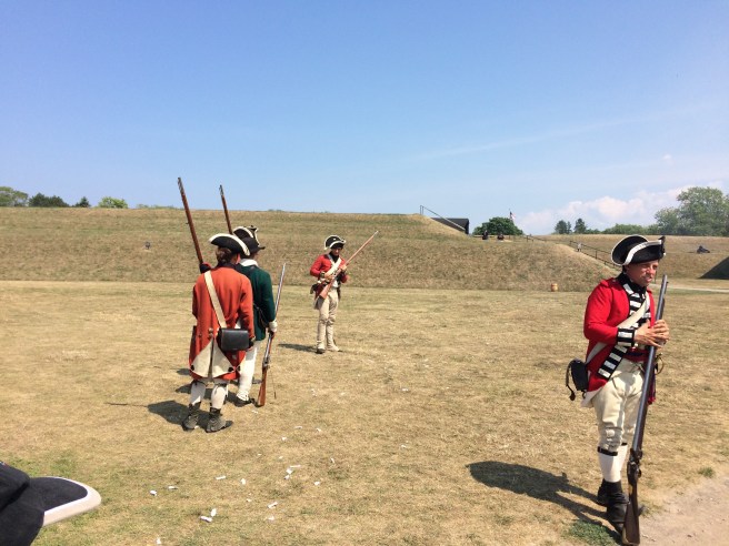 King George's loyal soldiers doing target practice at a barrel at Ft. Niagara, New York. These brave souls were wearing period costumes of all natural fibers (i.e., wool, primarily, and cotton) in 95-degree heat. 