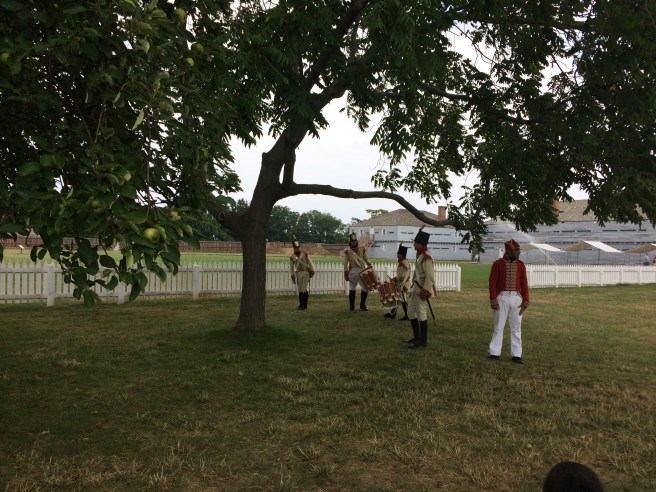 Fort George musicians and historians discussing the fort and their duties during the War of 1812. The soldier in red translated for French-speaking guests.